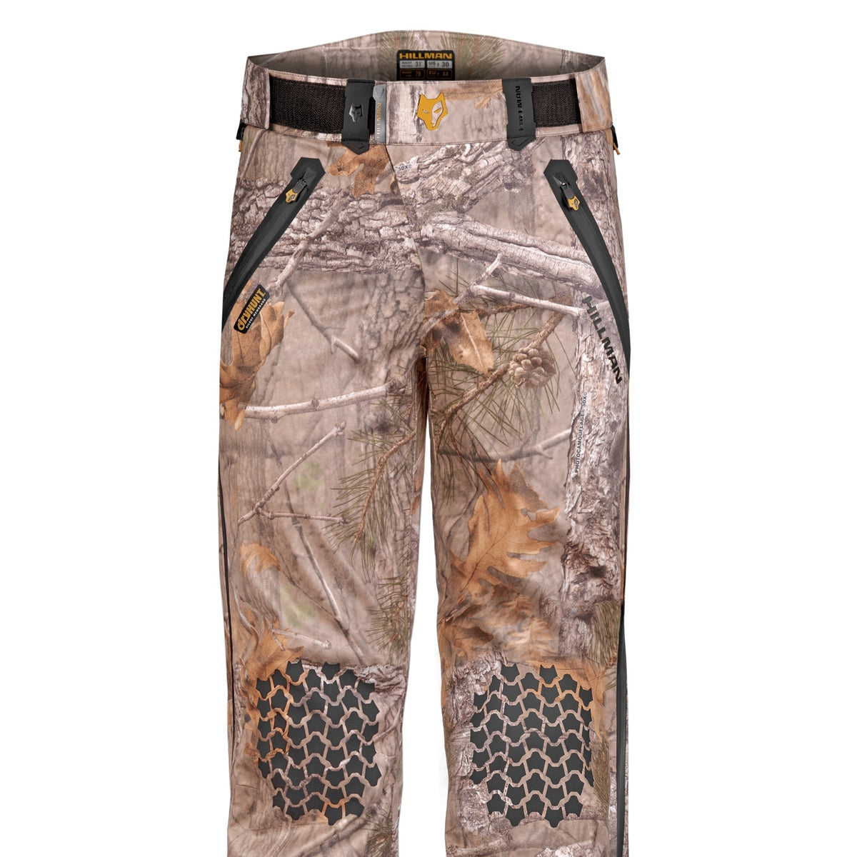Die wasserdichte Regenhose 5WL von Hillman – Jagdhose – besticht durch ein Baum- und Blättertarnmuster, schwarze Reißverschlüsse an den Vordertaschen, eine Waben-Knieverstärkung und einen schwarzen Gürtel mit dezentem Logo am Bund. Für ultraleichten Komfort bei jedem Wetter.